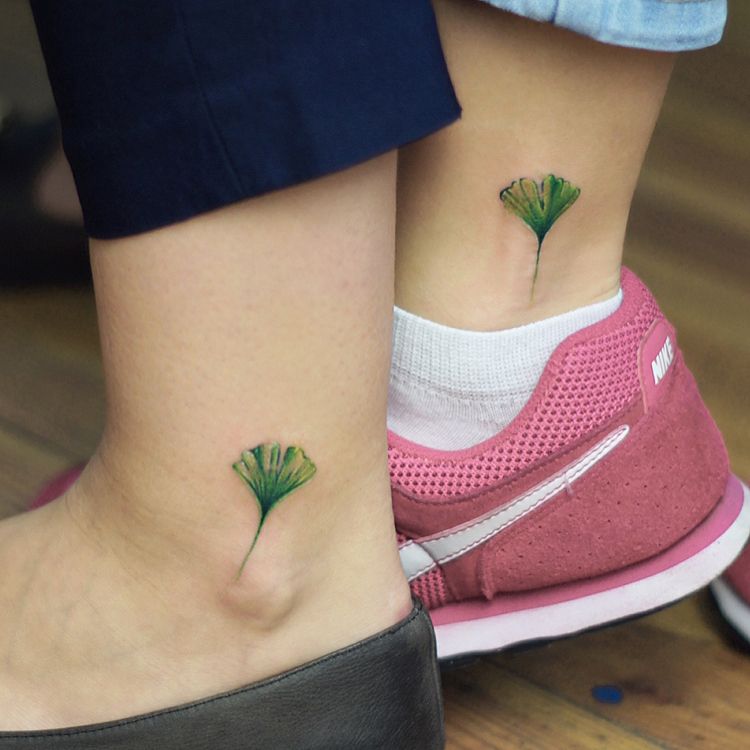 Matching botanical tattoo on the ankle