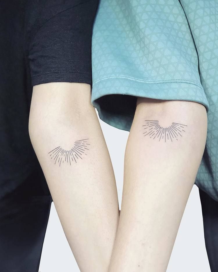 Matching half sun tattoos on arms