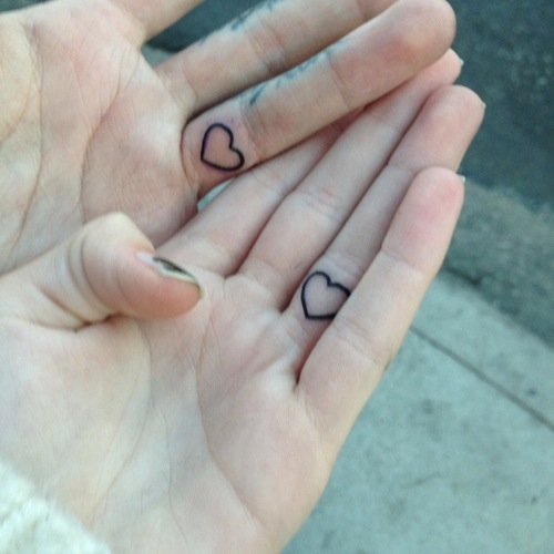 Matching little heart tattoos