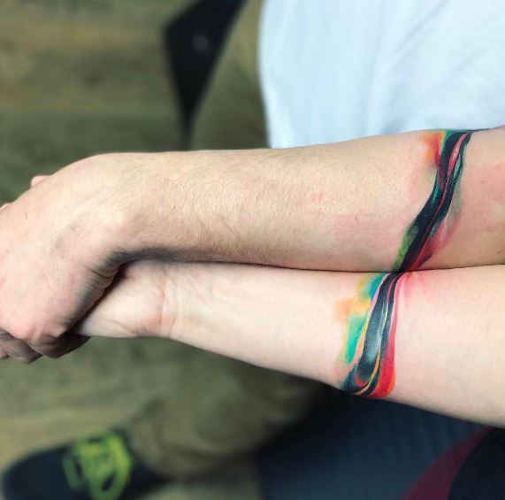 Matching watercolor armband tattoo