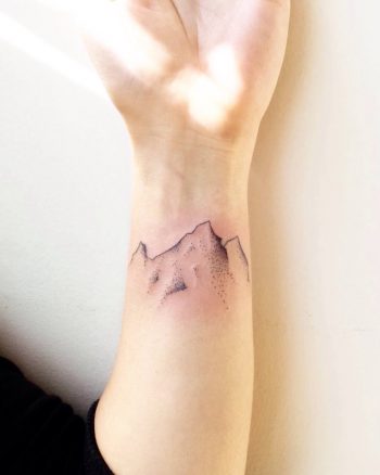 Minimalist dotwork mountain tattoo