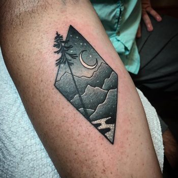 Mountainous landscape in a rhombus tattoo