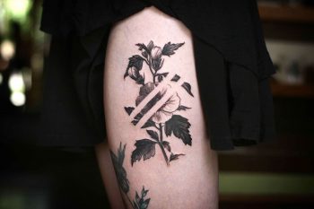 Negative space delicate flower tattoo