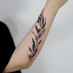 Olive branch tattoo on the forearm