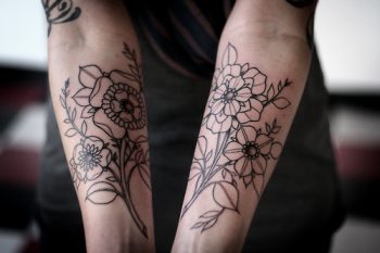 Outline black floral tattoos on both arms
