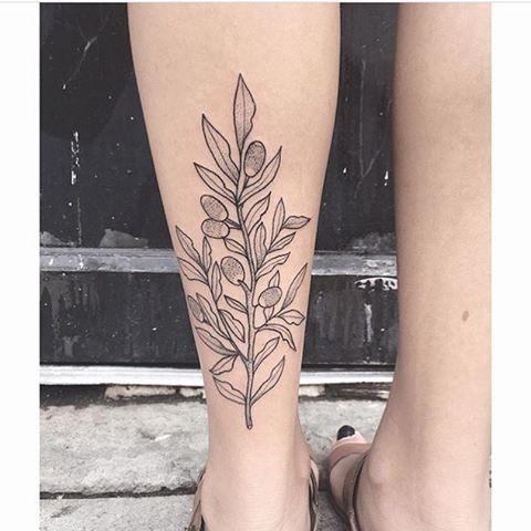 Outline floral tattoo on the left calf