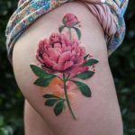 Peony tattoo on the right thigh