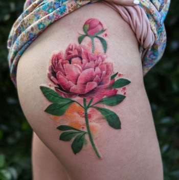 Peony tattoo on the right thigh