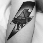 Piano in a lightning bolt tattoo