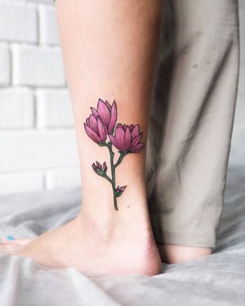 Pink flower tattoo on the ankle