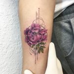 Pink flower tattoo on the right inner arm