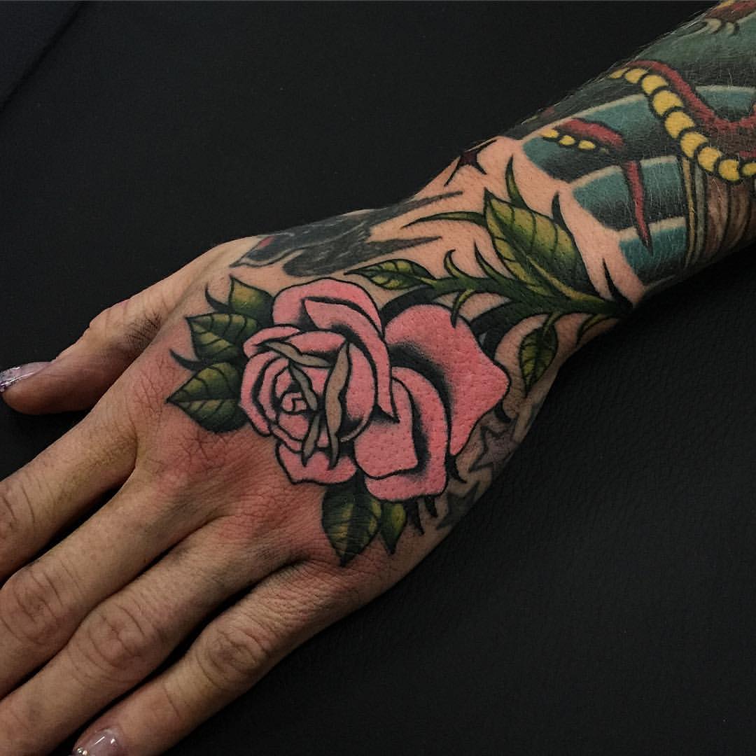 Pink rose tattoo on the hand