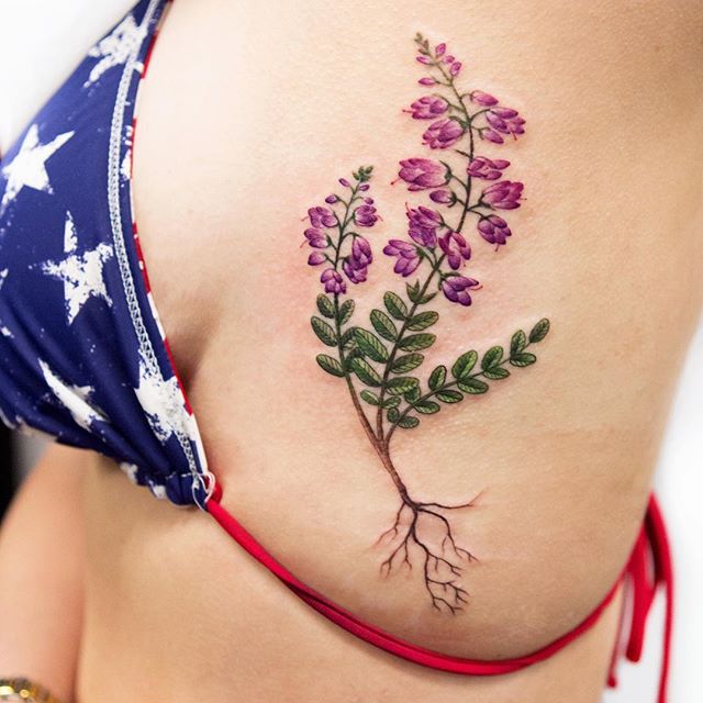 Purple and green wildflower tattoo