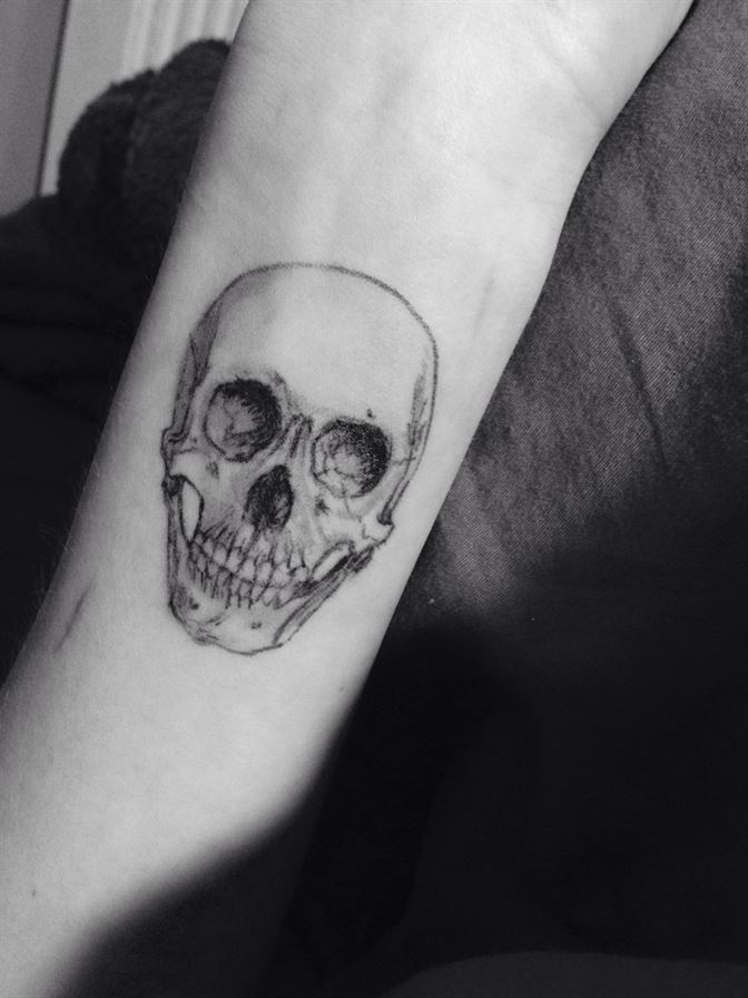 Realistic black human skull tattoo