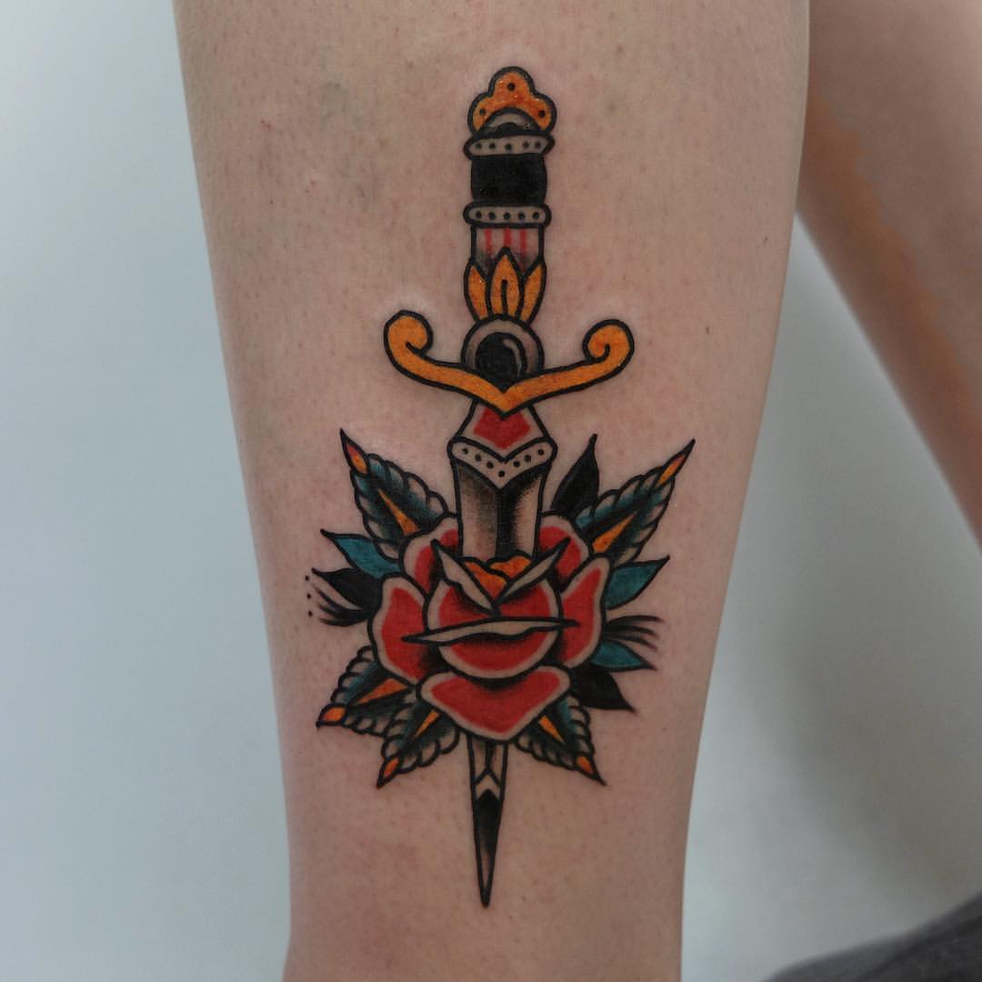 Rose stabbed with a dagger tattoo