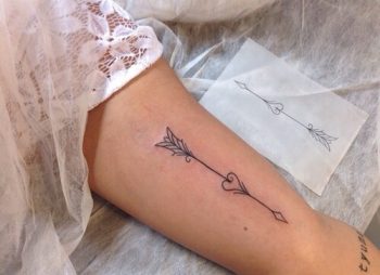 Small arrow stabbed heart tattoo