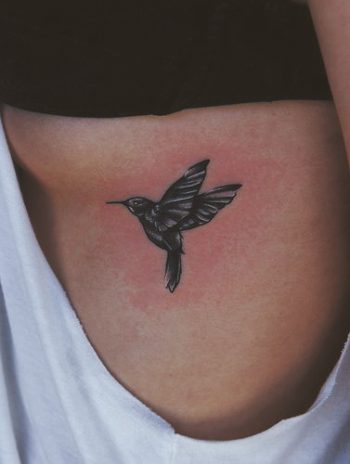 Small black colibri tattoo