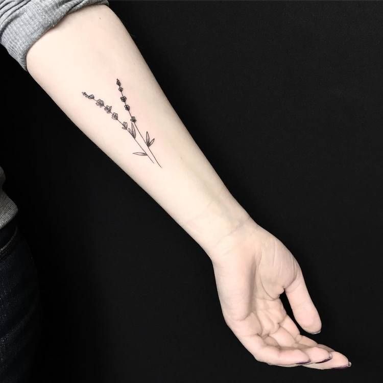 Small botanical tattoo on the left inner arm