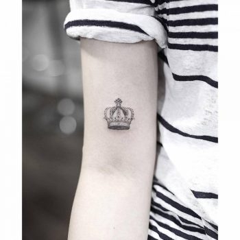Small crown tattoo on the arm