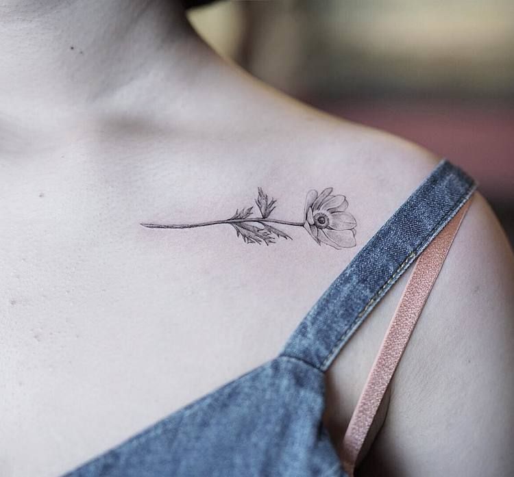 Small flower tattoo on the clavicle bone