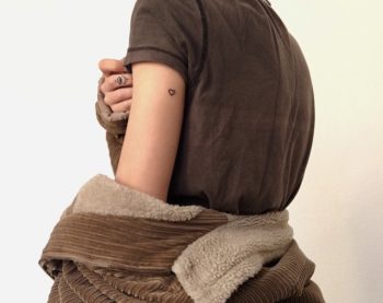Small hear tattoo on the upper arm