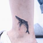 Small whale tattoo on the ankle