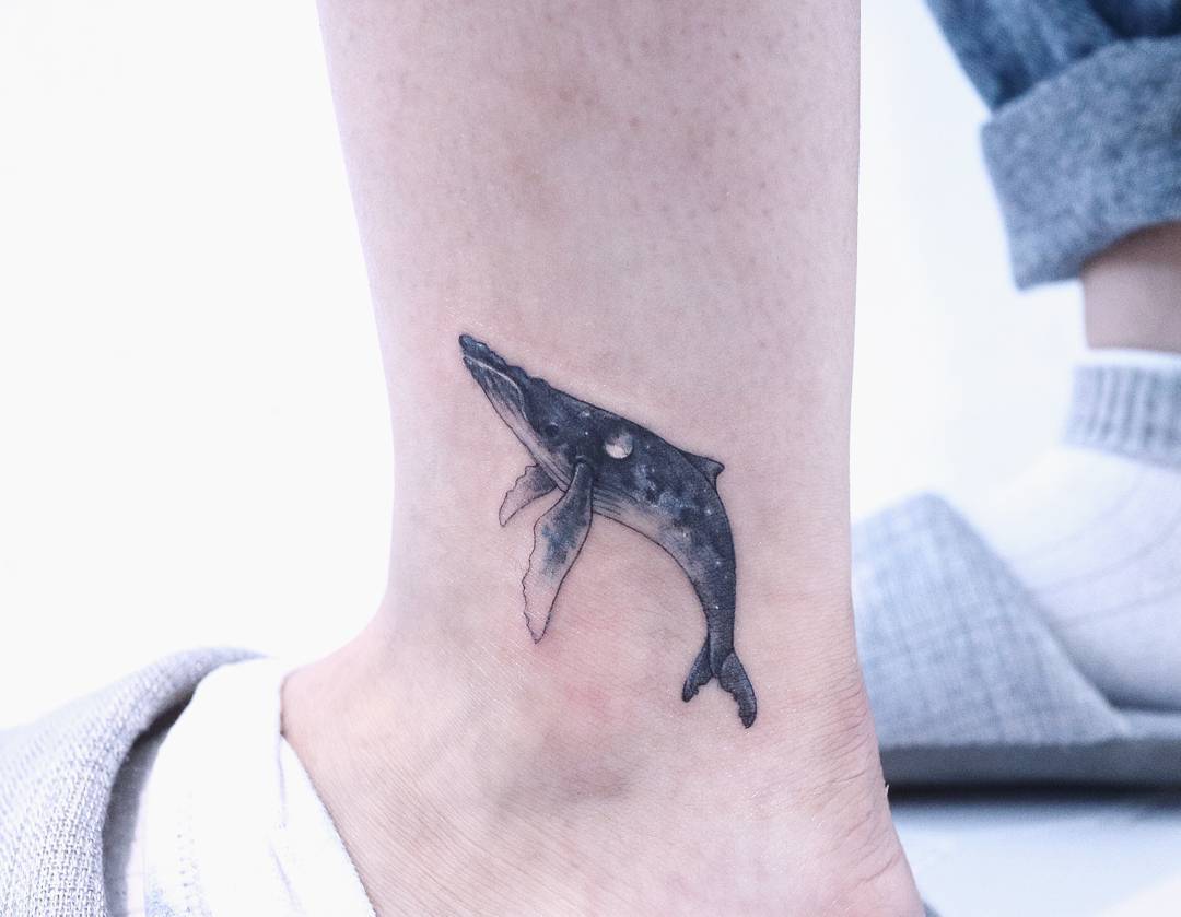 Small whale tattoo on the ankle