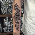 Snake wrapped around the dagger tattoo