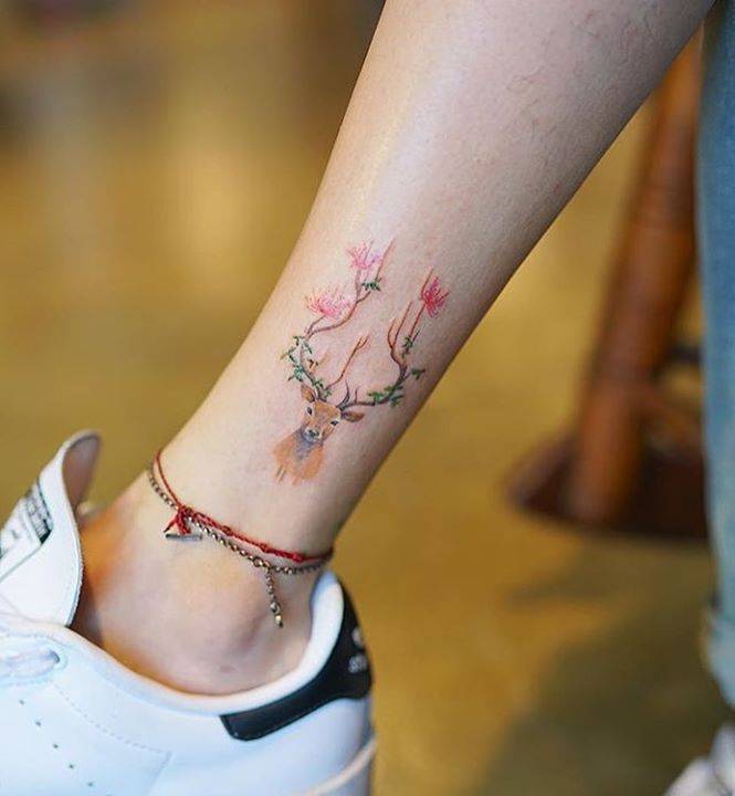 Stylized deer tattoo on the ankle