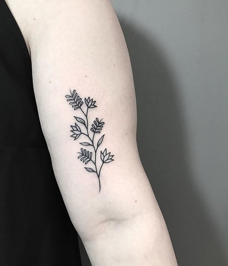 Subtle black flower tattoo