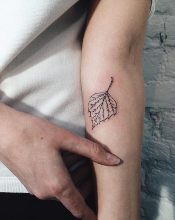 Subtle black leaf tattoo