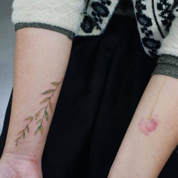 Subtle flower tattoos on arms
