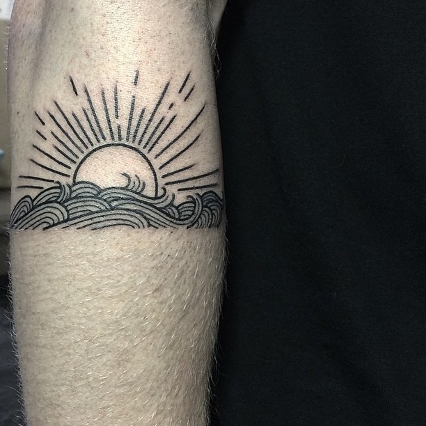 Sun behind the waves tattoo