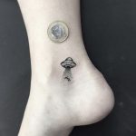 Tiny alien spaceship tattoo
