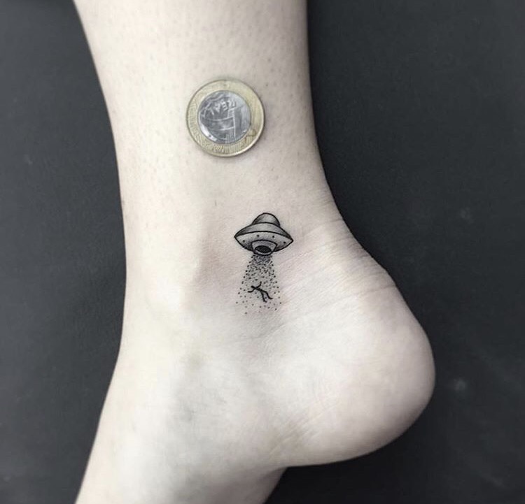 Tiny alien spaceship tattoo