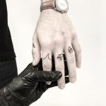 Tiny black finger tattoos