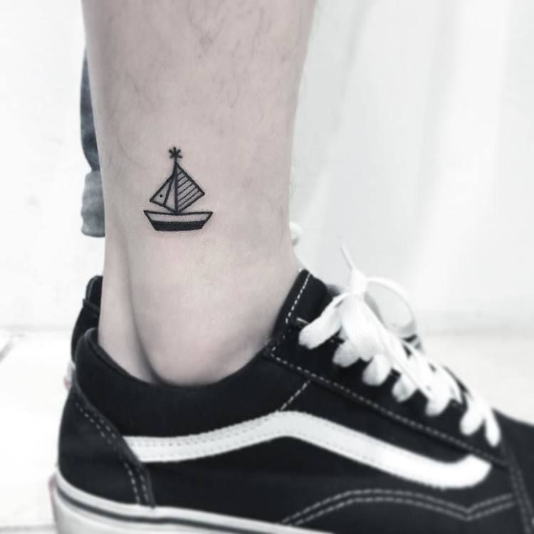 Tiny boat tattoo on the ankle