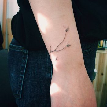 Tiny branch tattoo on wrist