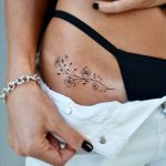Tiny flower tattoo on the right hip