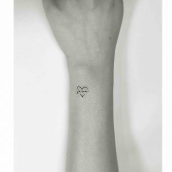 Tiny heart tattoo with a word