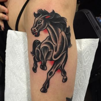 Traditional black horse tattoo