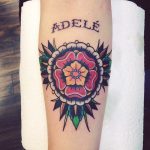 Traditional flower tattoo with a name adele