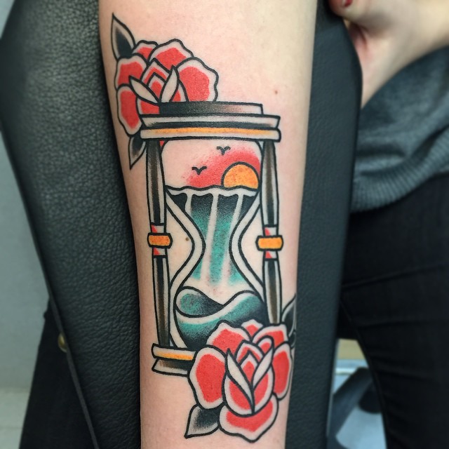 Traditional hourglass tattoo on the arm