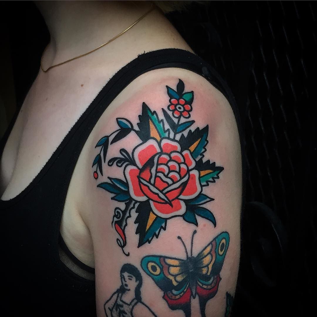 Traditional rose tattoo on the left shoulder