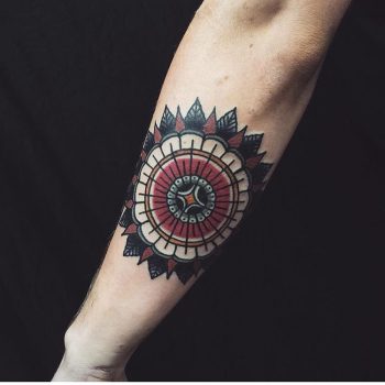Traditional style mandala forearm tattoo