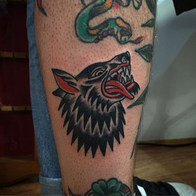 Traditional wolf tattoo on the leg 
