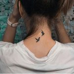 Two birds tattoo on the neck