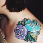 Violet and teal flowers tattoo