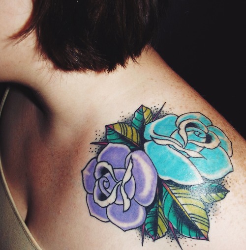 Violet and teal flowers tattoo