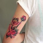 Watercolor flower tattoo on the arm